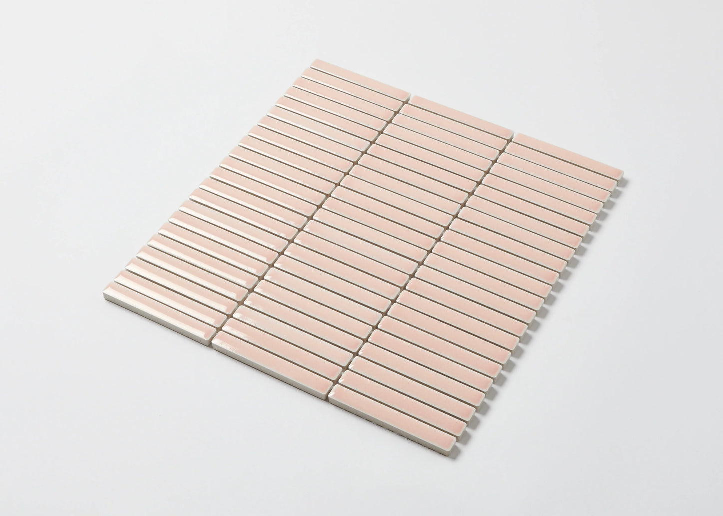 Pack shot of Antique Pale Pink Gloss Porcelain Glazed KitKat 12x92mm mosaic sheet showing glossy blush pink elongated finger tiles arranged in a uniform horizontal stack bond pattern.