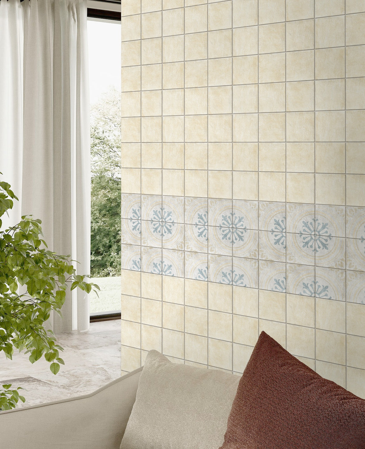 Antiquity Valencia Blue Decor 150x150mm tiles installed as a living room feature wall with a decorative border row, styled beside a sofa and indoor plant.
