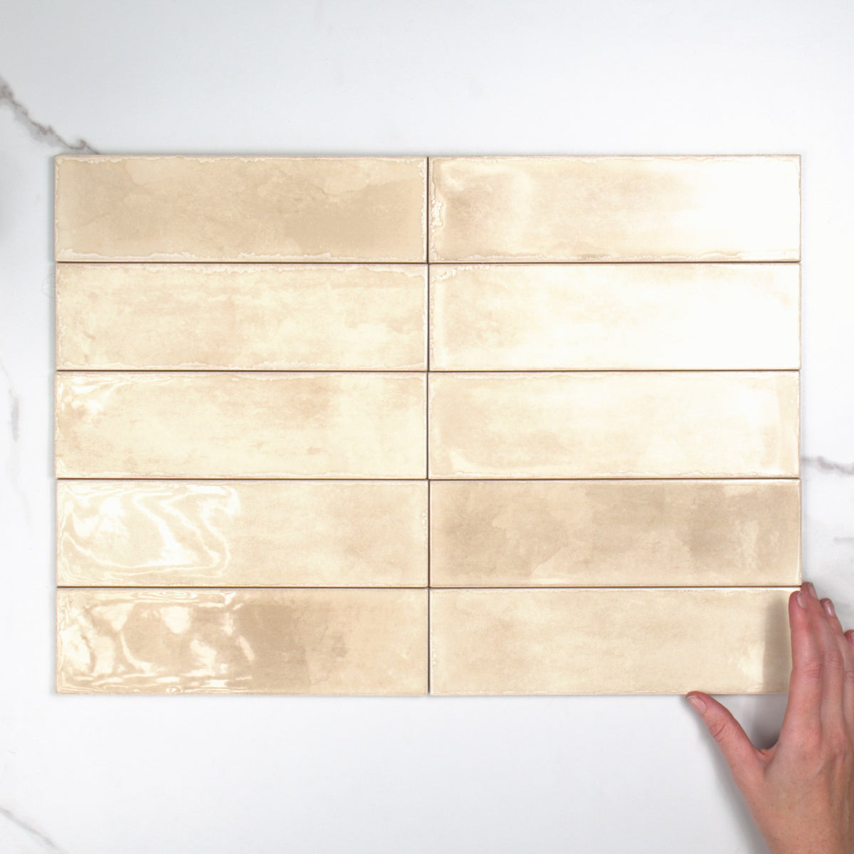 Atlantique Amande Gloss 69x240mm top view, hand for scale