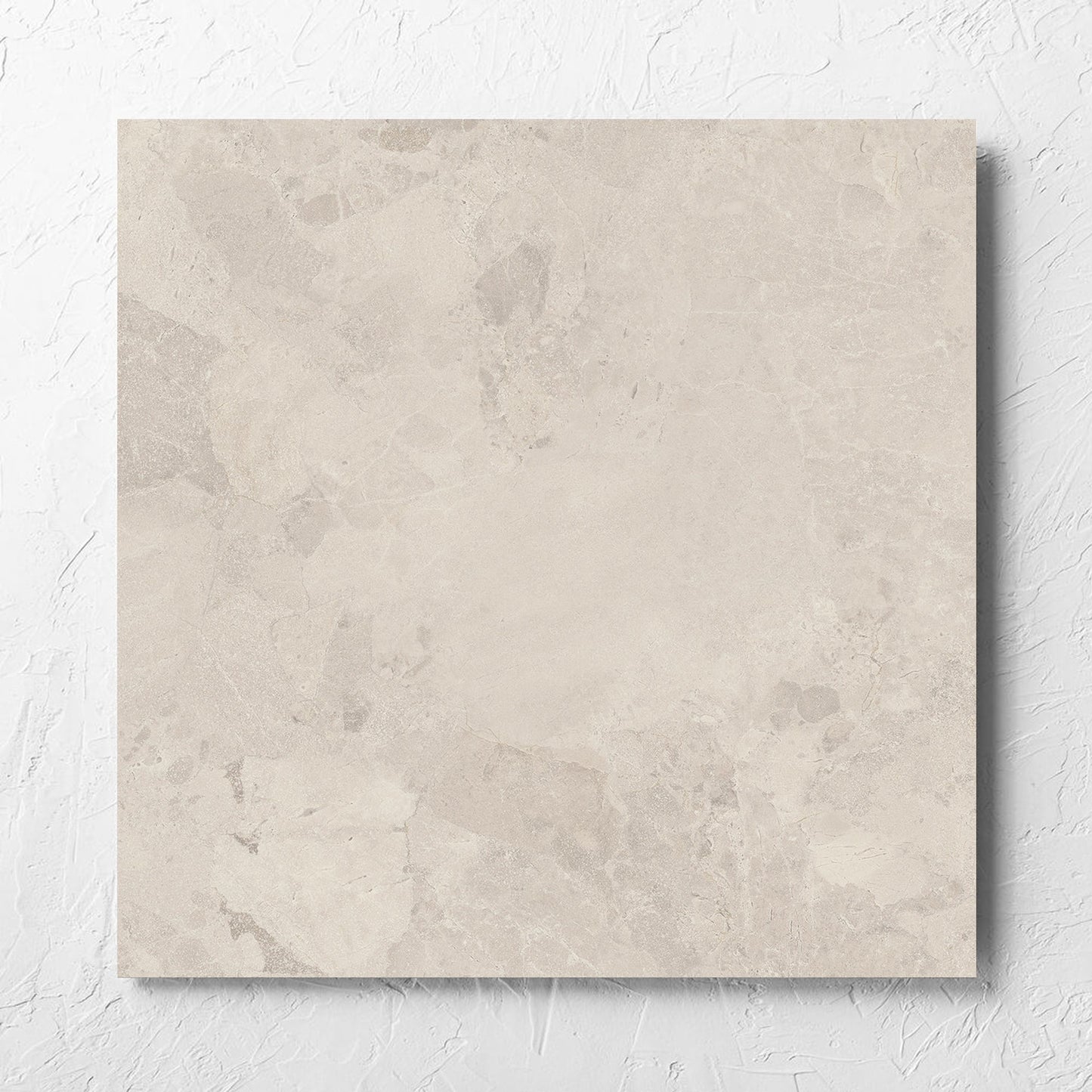 Aurelia Stone Ash Matt 600x600mm tile laid flat on a white rendered wall, showing the matt surface