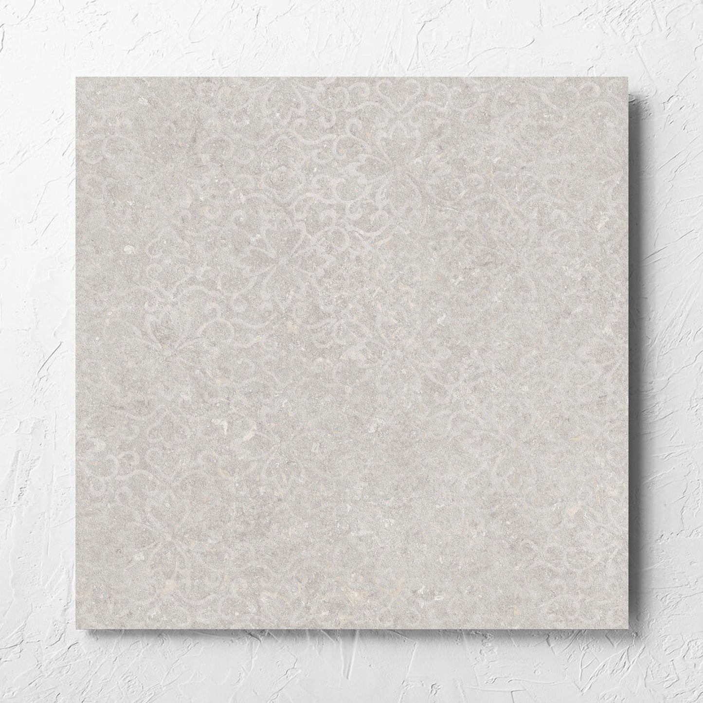 Brighton Stone Matt 600x600mm tile laid flat on a white rendered wall, showing the matt surface