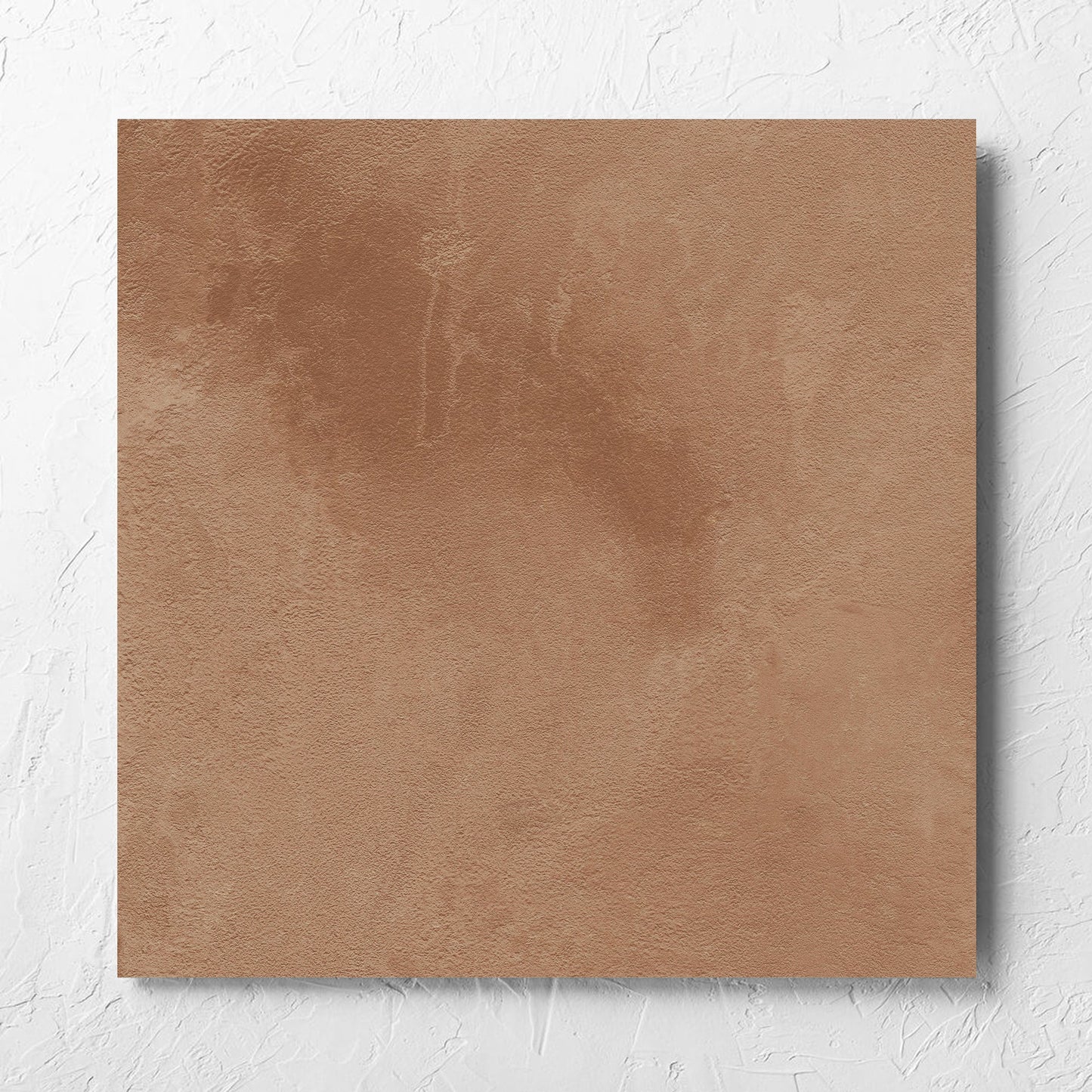 Clay Firenze Dark Terracotta 600x600mm tile laid flat on a white rendered wall, showing the matt surface