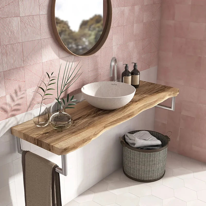 Dune Trazos Flamingo 147x147mm pink geometric wall tiles installed in a stylish bathroom featuring a live-edge wood vanity shelf and round mirror.