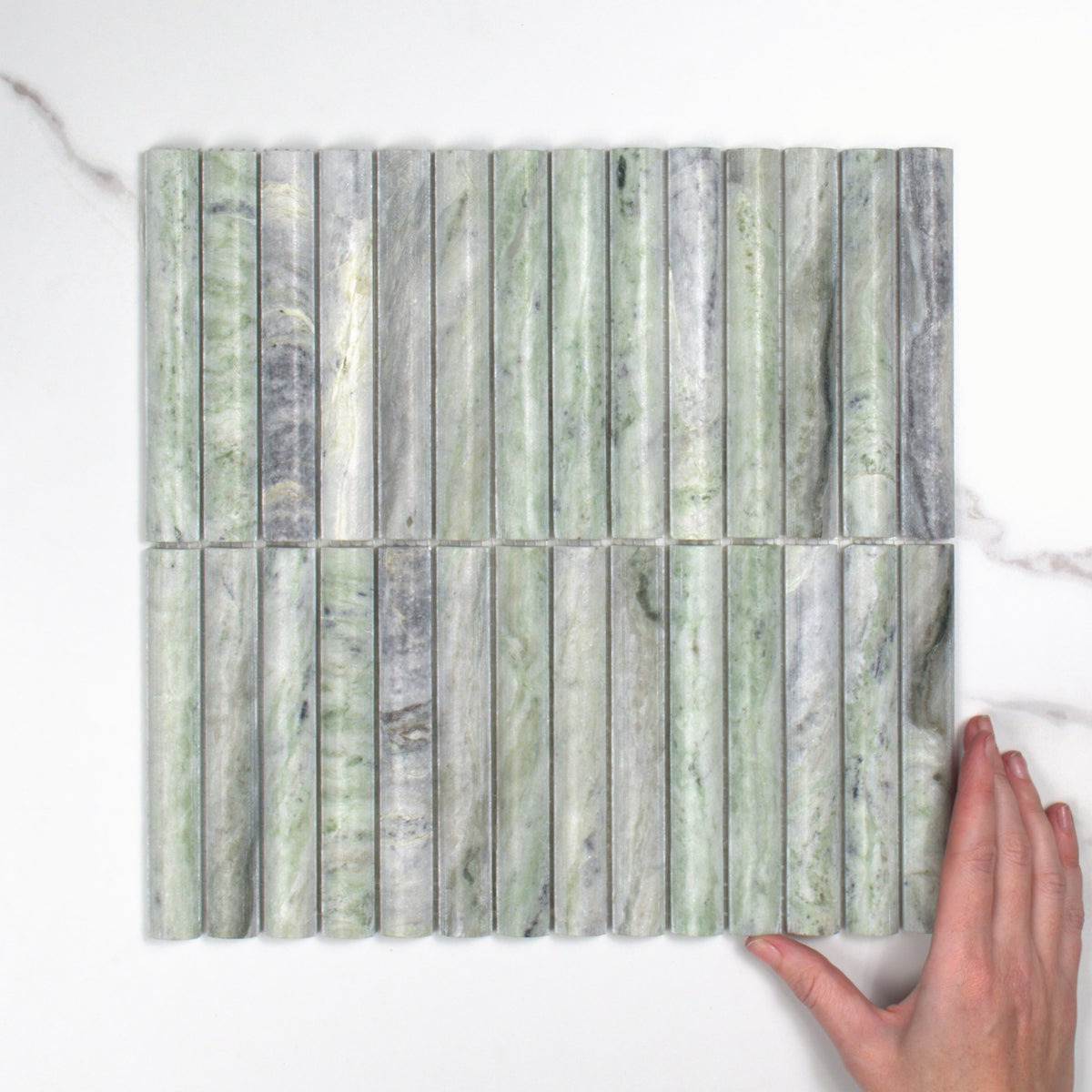 Elementa Cloud Emerald Fluted Mosaic 20x148mm top view, hand for scale