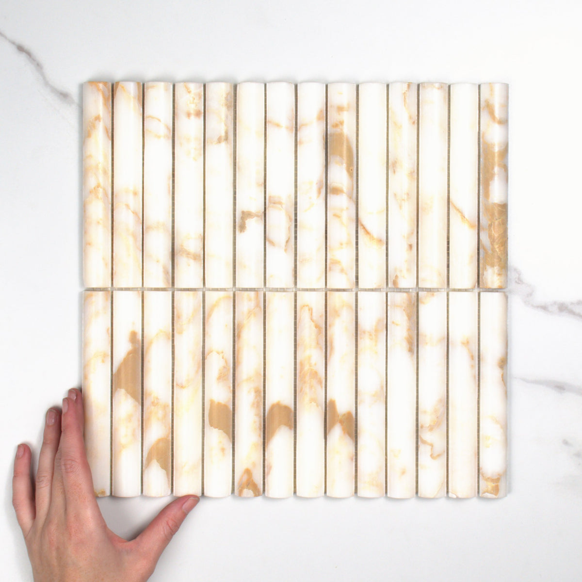 Elementa Cream Block Fluted Mosaic 20x148mm top view, hand for scale