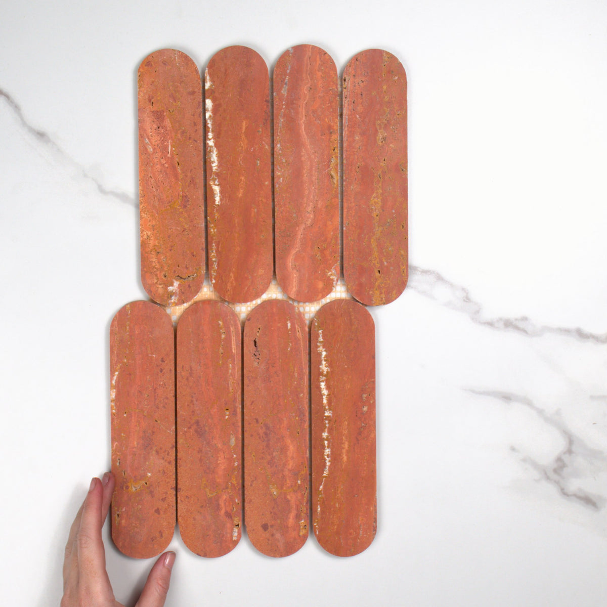 Elementa Travertine Red Cylinder Mosaic 50x198mm top view, hand for scale