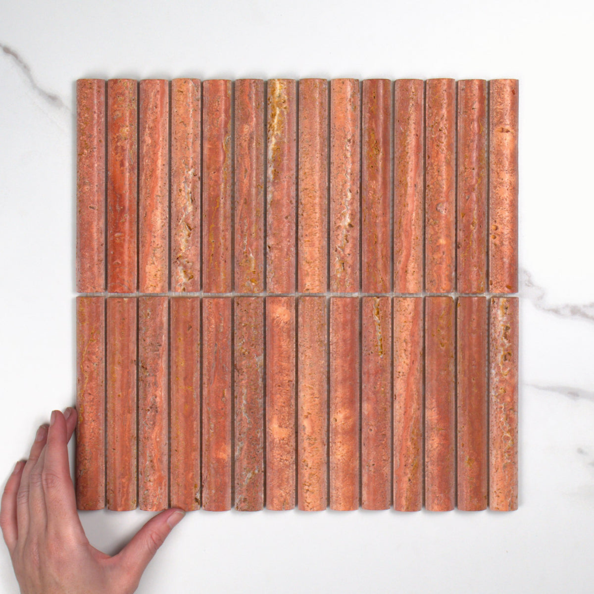 Elementa Travertine Red Fluted Mosaic 20x148mm top view, hand for scale