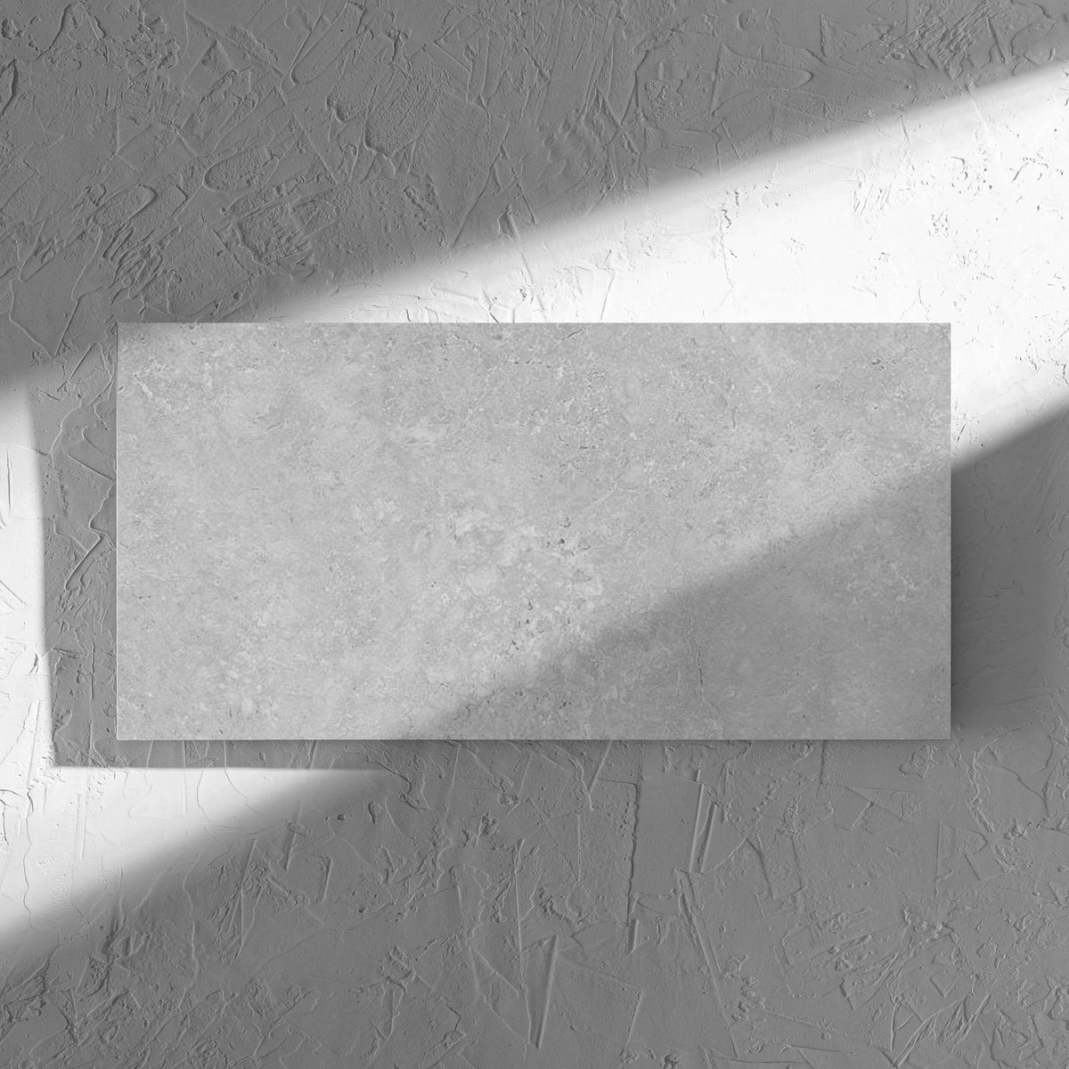 Kross Light Grey Matt Smooth Grip 300x600mm tile in soft natural window light, showing the tile surface