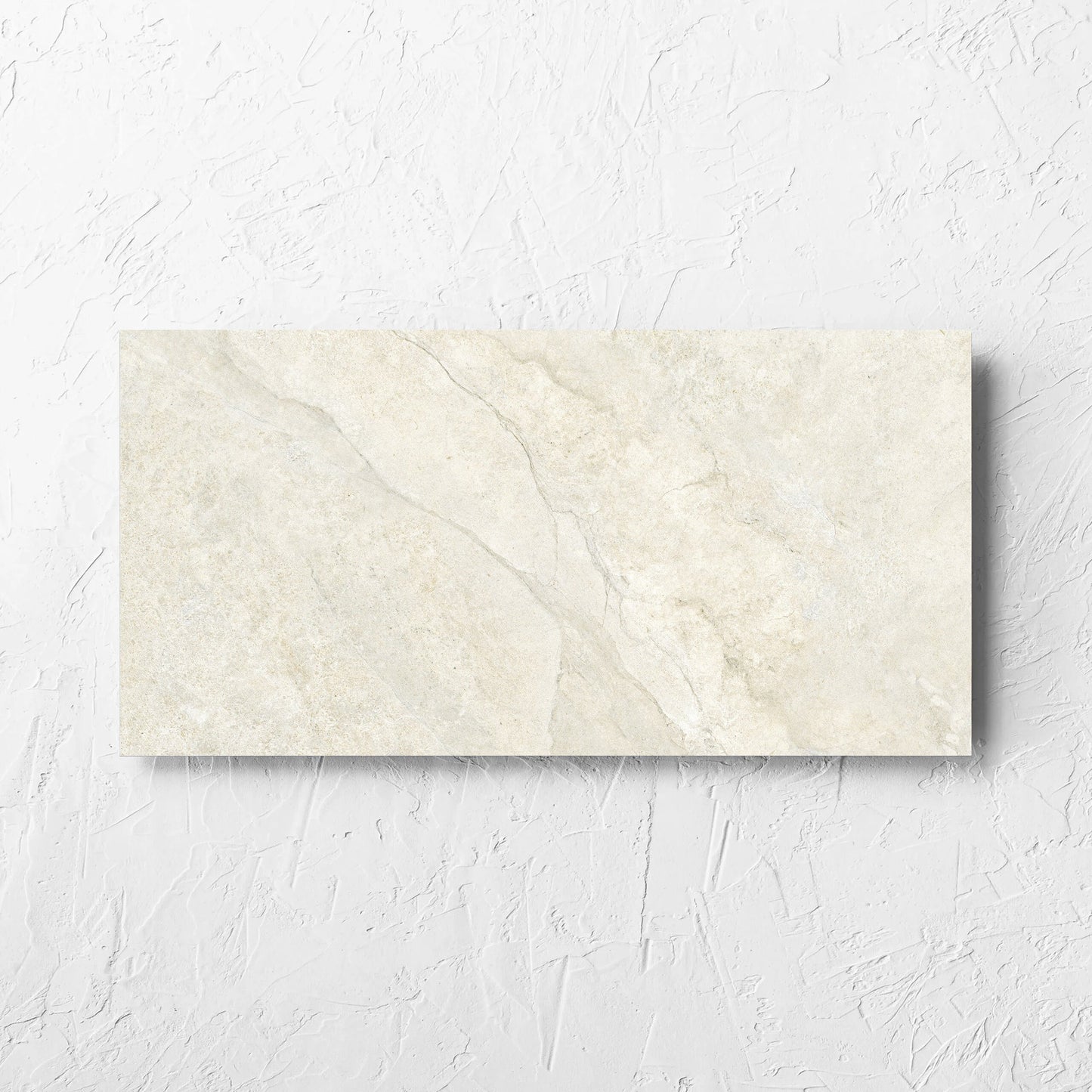 Lakestone Sand Matt 300x600mm tile laid flat on a white rendered wall, showing the matt surface