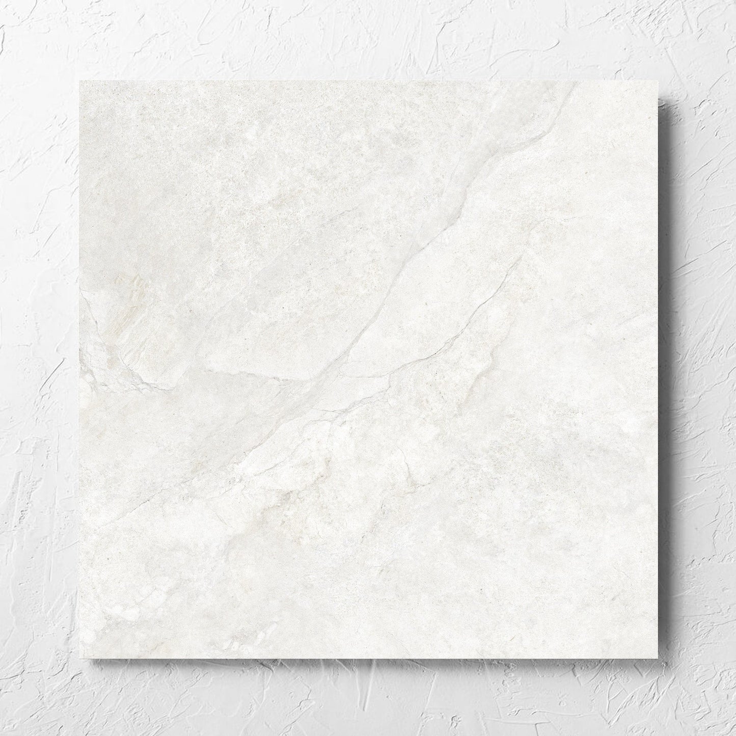 Lakestone White Matt 600x600mm tile laid flat on a white rendered wall, showing the matt surface