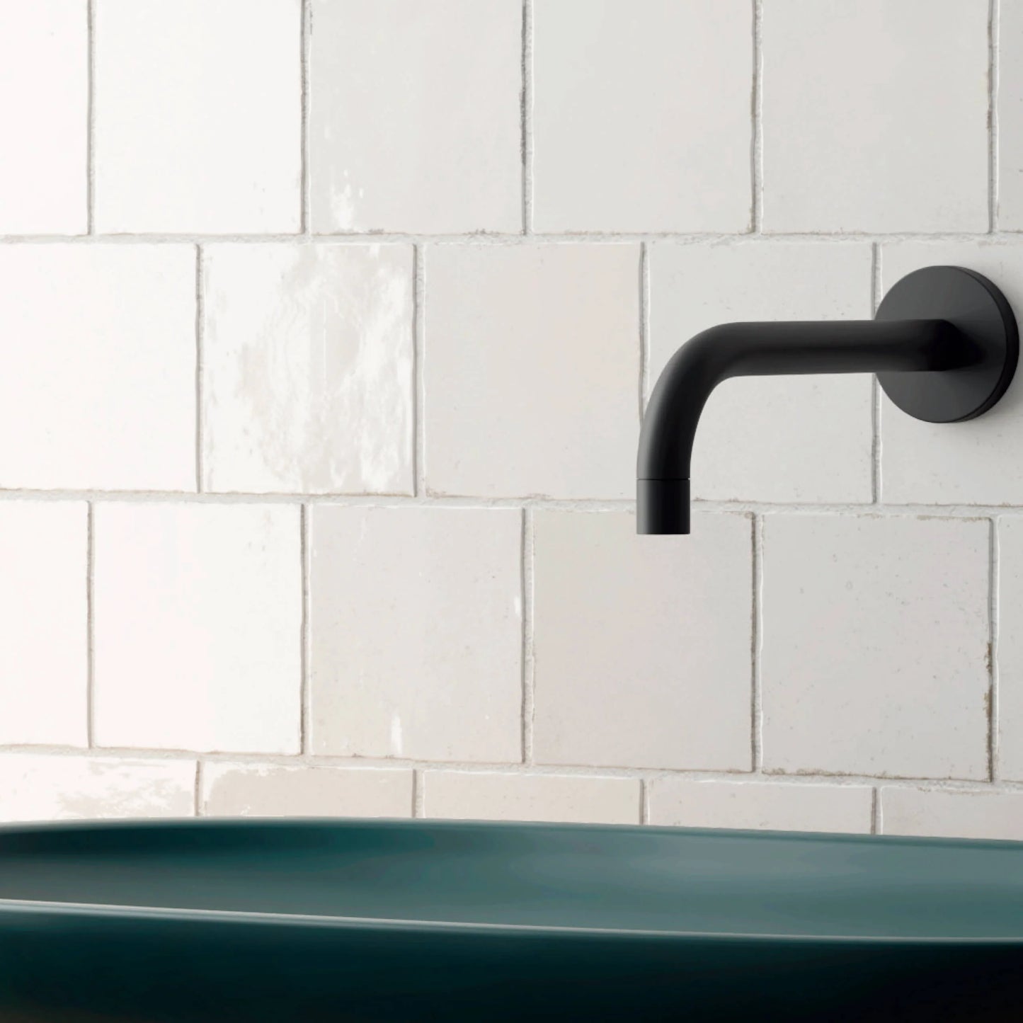 Majorca Gloss White 100x100mm tiles installed as a bathroom feature wall behind a teal vessel basin with a matte black wall-mounted spout.