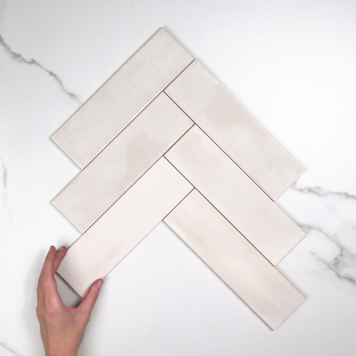 Milano Gesso Matt 69x240mm top view, hand for scale