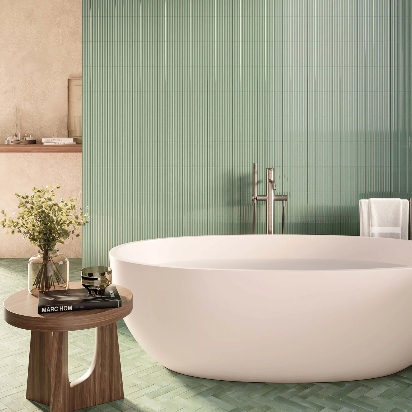 Mini Green Matt 50x150mm vertical stack tiles covering a full bathroom feature wall behind a white oval freestanding bathtub and brushed steel filler.