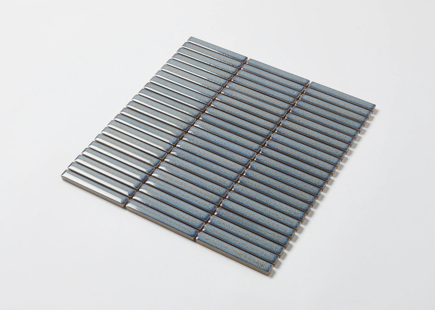 Pack shot of Mottled Grey Gloss Porcelain Glazed KitKat 12x92mm mosaic tile sheet showing slim blue-grey finger tiles with a speckled glaze finish arranged in parallel rows.