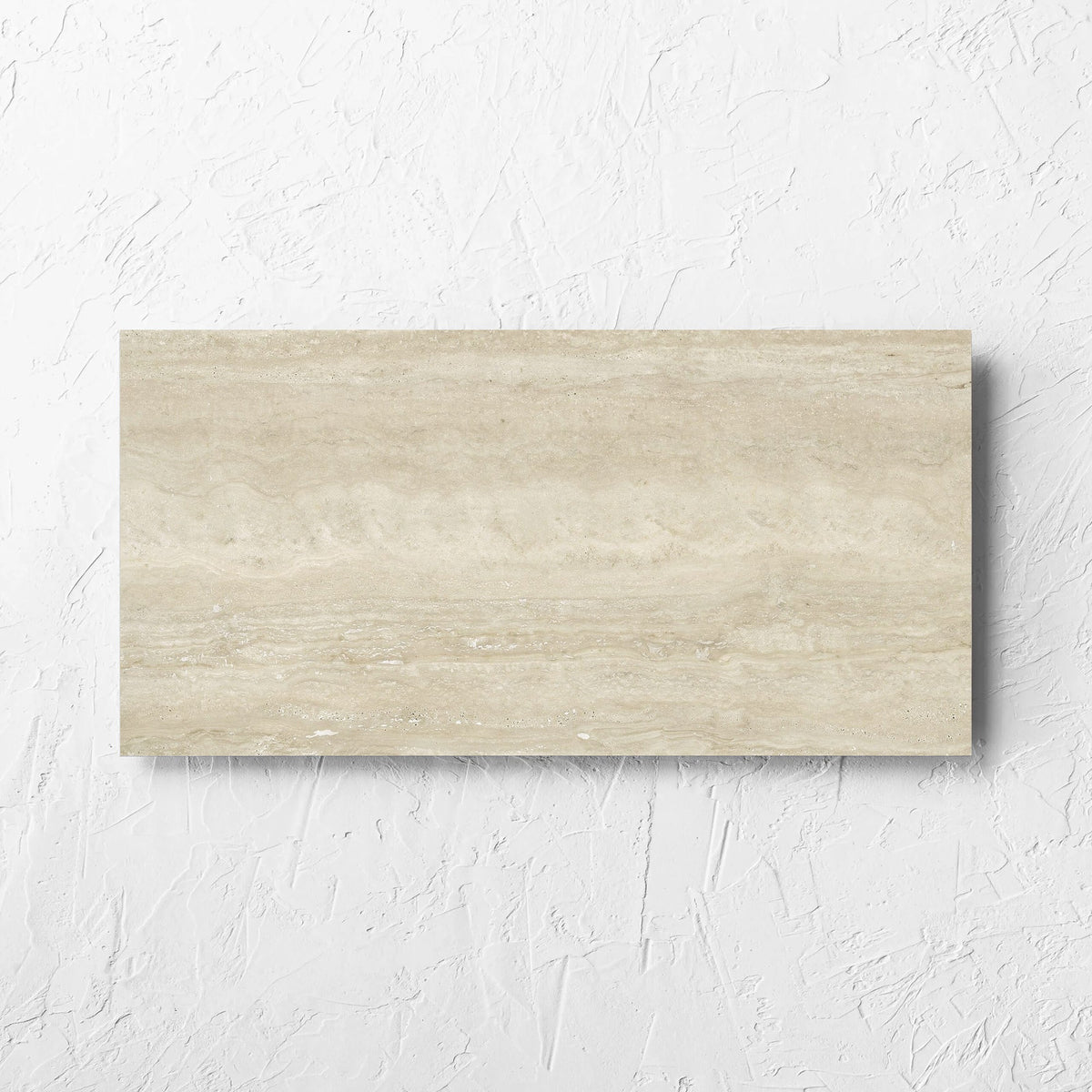 Norcia Vein Cut Beige 300x600mm tile laid flat on a white rendered wall, showing the beige matt surface