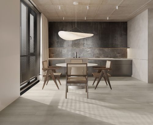 Oakland Balsa 200x1200mm light beige matte floor tiles installed in a modern open-plan dining and kitchen space with rattan chairs and oval pendant light.