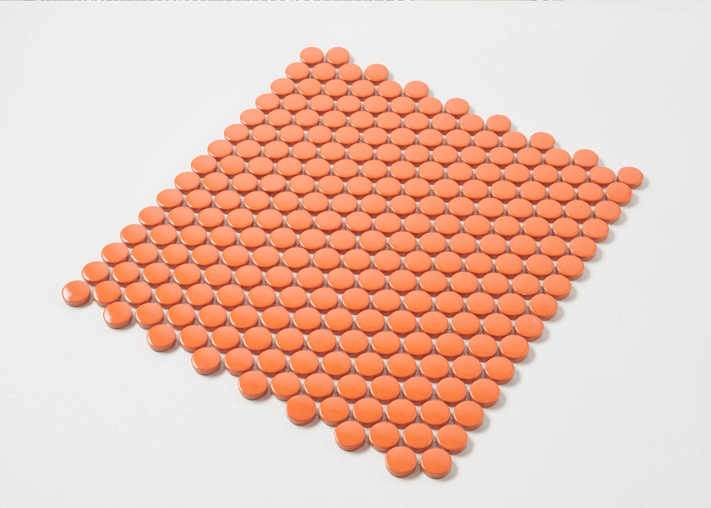 Orange Gloss Diameter Glazed Porcelain Penny Round 19mm tiles arranged in a diamond shape, showing glossy circular mosaic pieces in a vibrant orange finish.