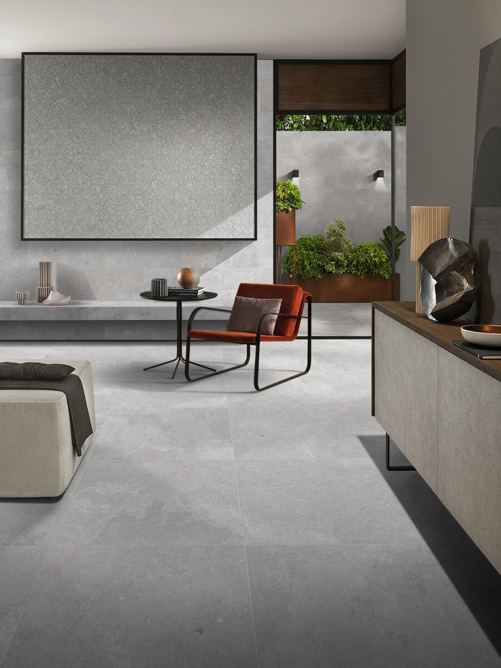 Provence Ash Lapatto Rectified 600x600mm tiles installed as a living room floor and feature wall, styled with a rust velvet armchair and lush greenery.