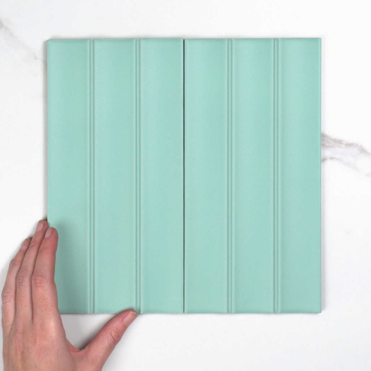Scala Menta Matt 115x231mm top view, hand for scale