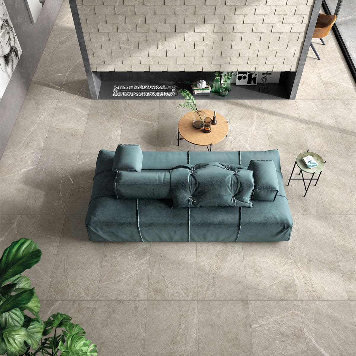 Soap Stone White Honed 600x1200mm porcelain tiles covering a spacious living room floor, styled with a teal velvet sofa, round timber coffee table, and textured feature wall.