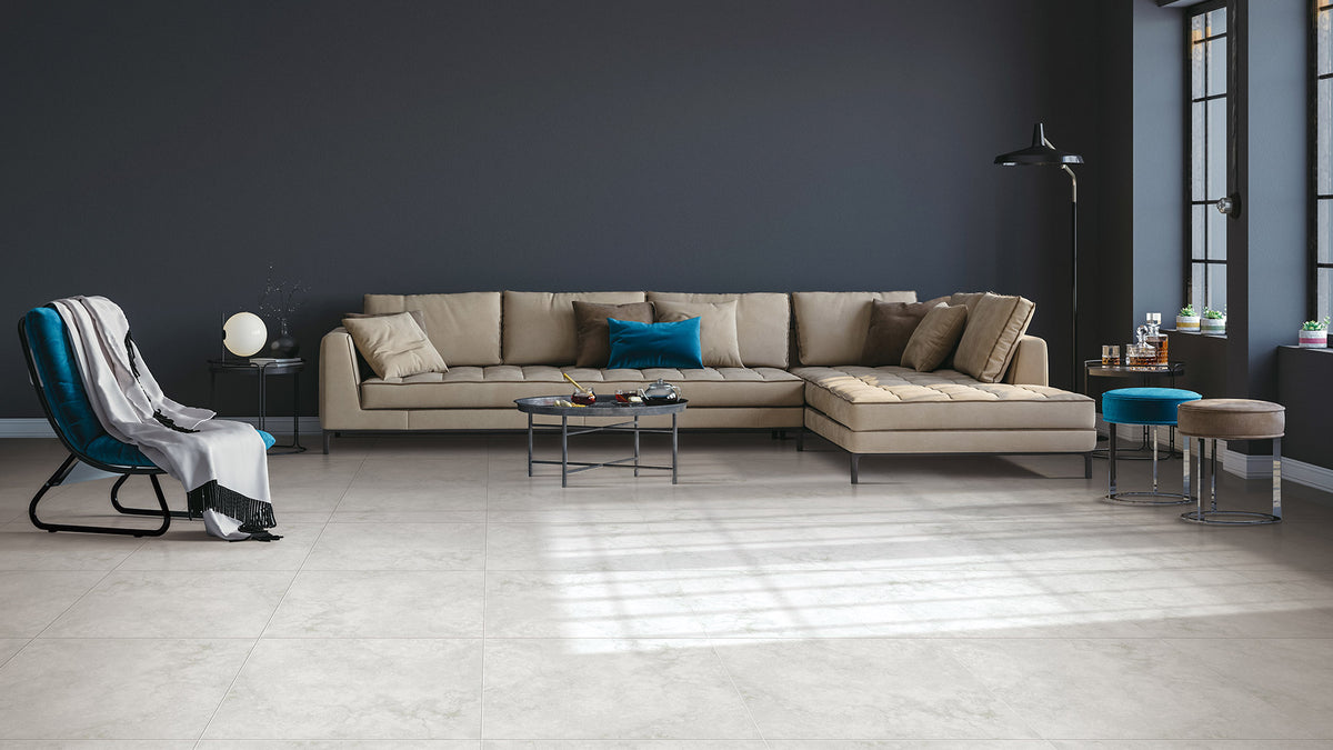 Timeless White Structured 600x600mm large-format floor tiles installed in a modern living room with a beige sectional sofa and dark feature wall.