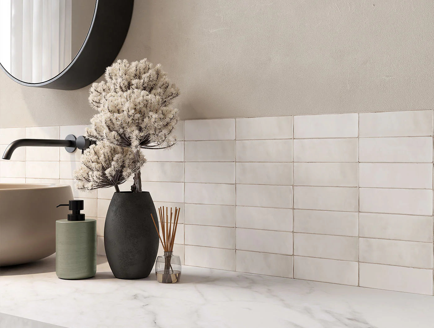 Tint Blanc Matt Subway 52x160mm tiles installed as a bathroom backsplash behind a marble vanity, round mirror, and decorative vase.