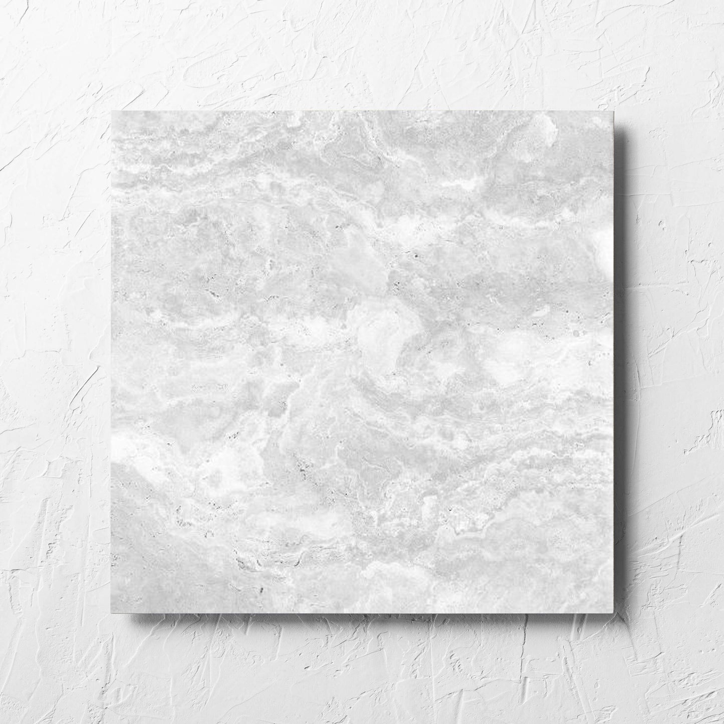Tivoli Silver Matt 450x450mm tile laid flat on a white rendered wall, showing the matt surface