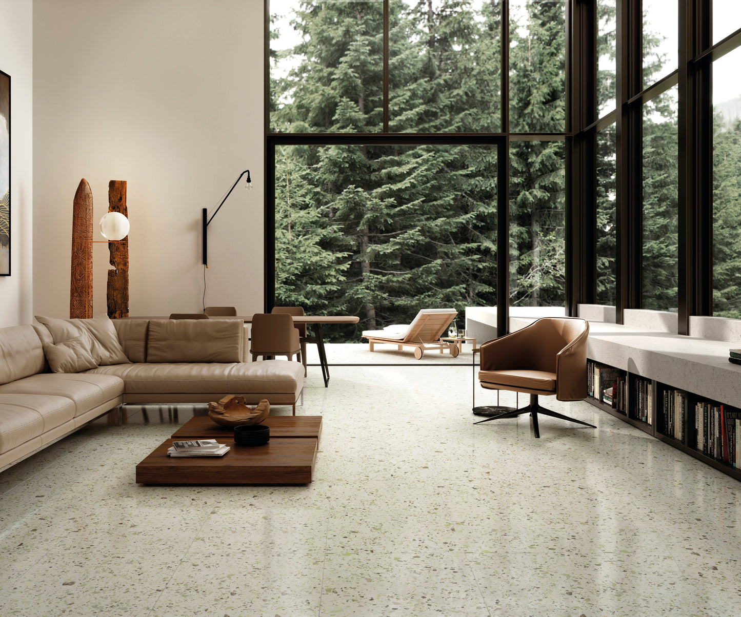 Venice Green 600x600mm Matt Terrazzo Tile installed in a bright open-plan living room with leather sofa, wooden coffee table, and floor-to-ceiling forest views.