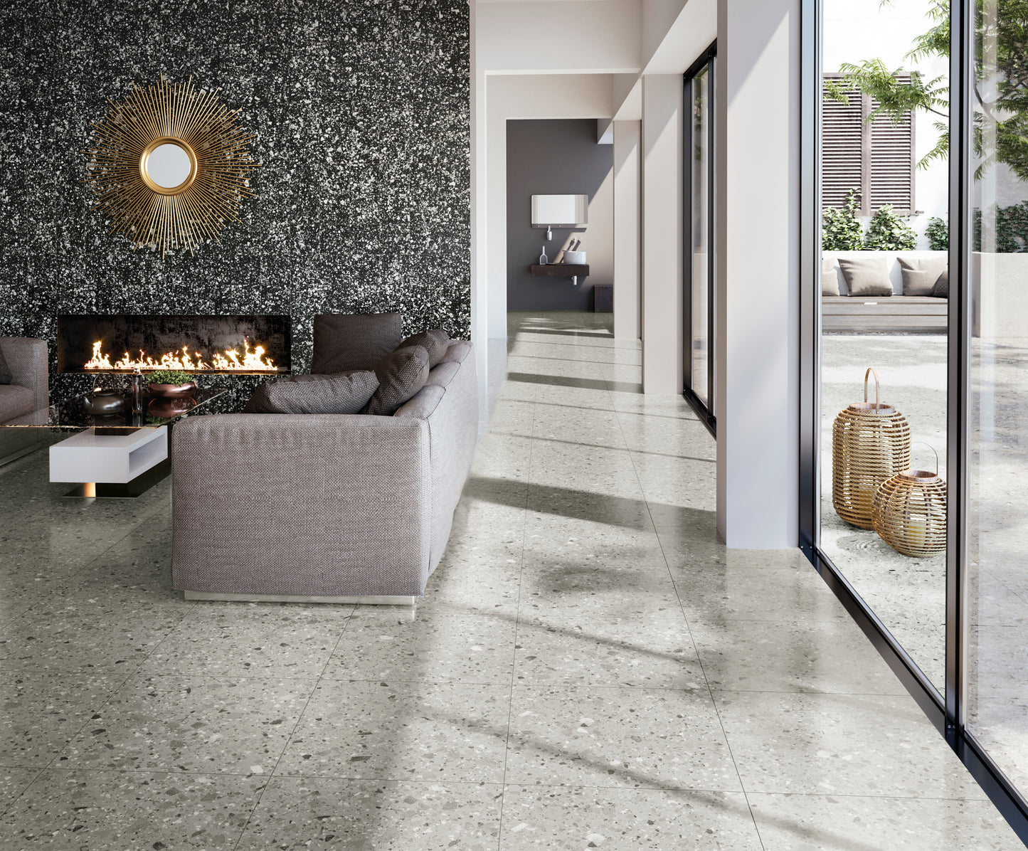 Venice Grey 300x600mm Matt Terrazzo Tile installed across a modern living room floor featuring a linear fireplace, grey sofa, and floor-to-ceiling glazing.