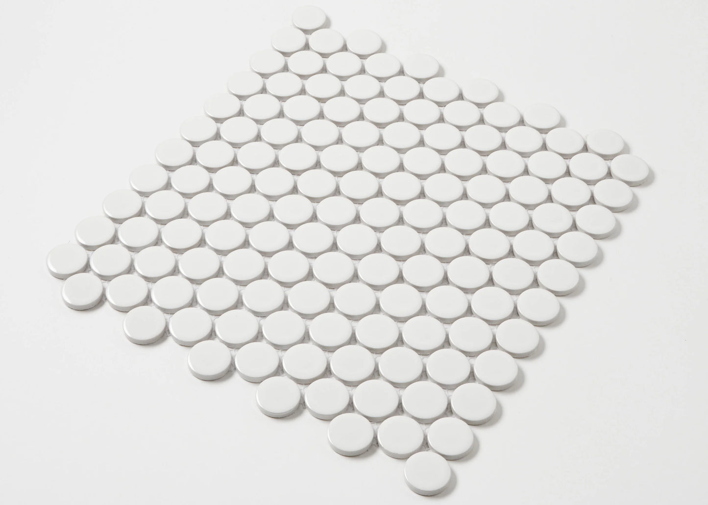 White Gloss Glazed Porcelain Penny Round 28mm Diameter tiles arranged in a diamond-shaped mosaic sheet showing their circular glossy white finish.
