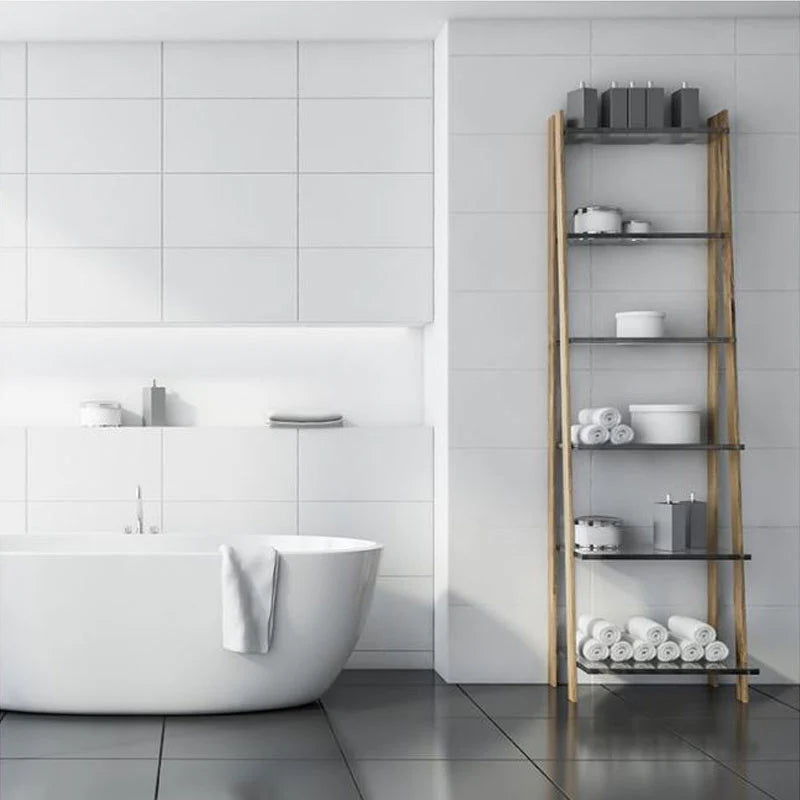 White Gloss Rectified 300x600mm wall tiles installed in a minimalist bathroom featuring a freestanding oval bath and ladder storage shelf.