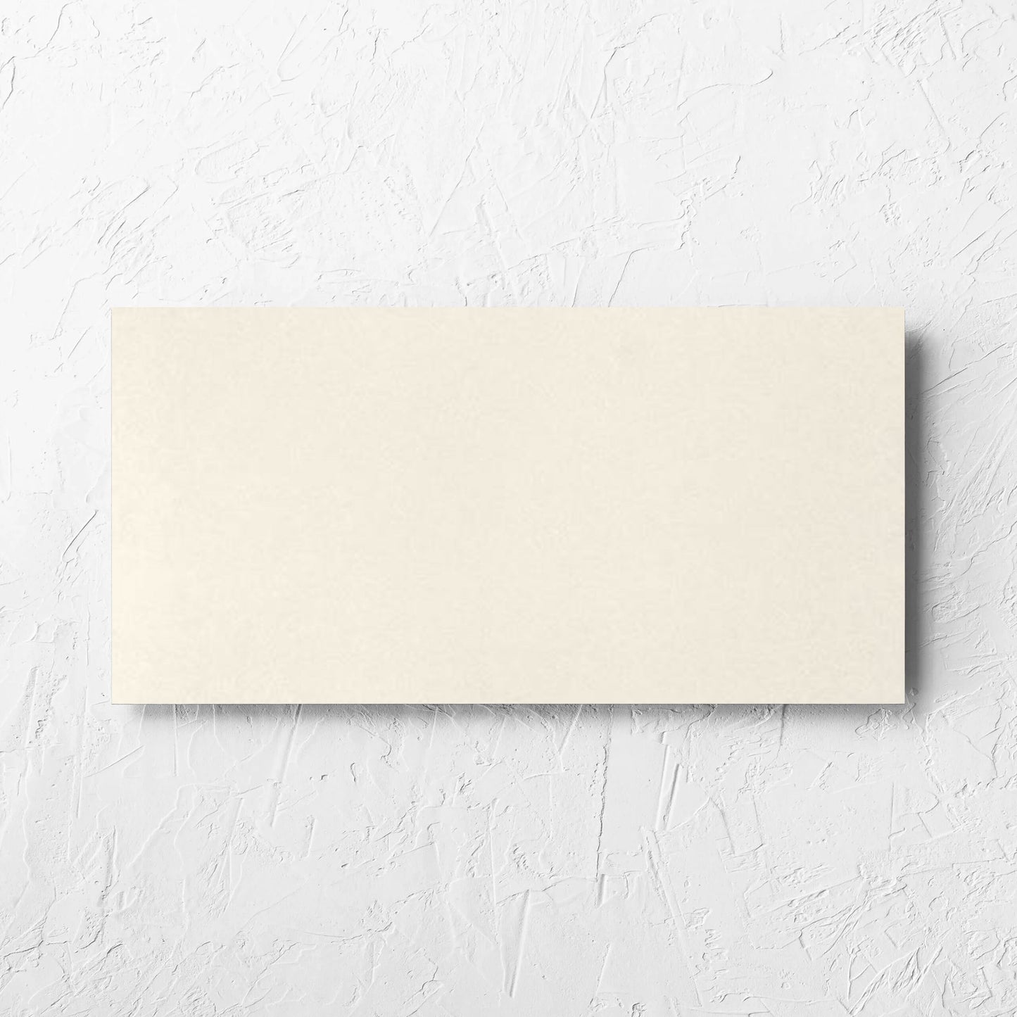 Yarra Soft Beige Satin 300x600mm tile laid flat on a white rendered wall, showing the tile surface