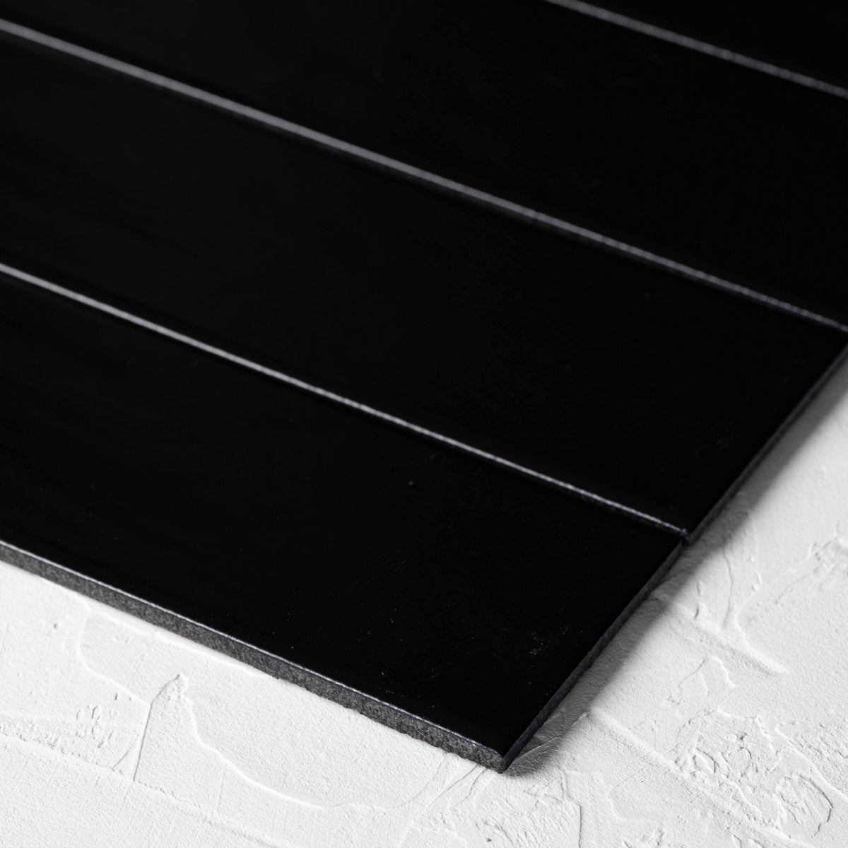 Brava Black Gloss 60x217mm tile on white background