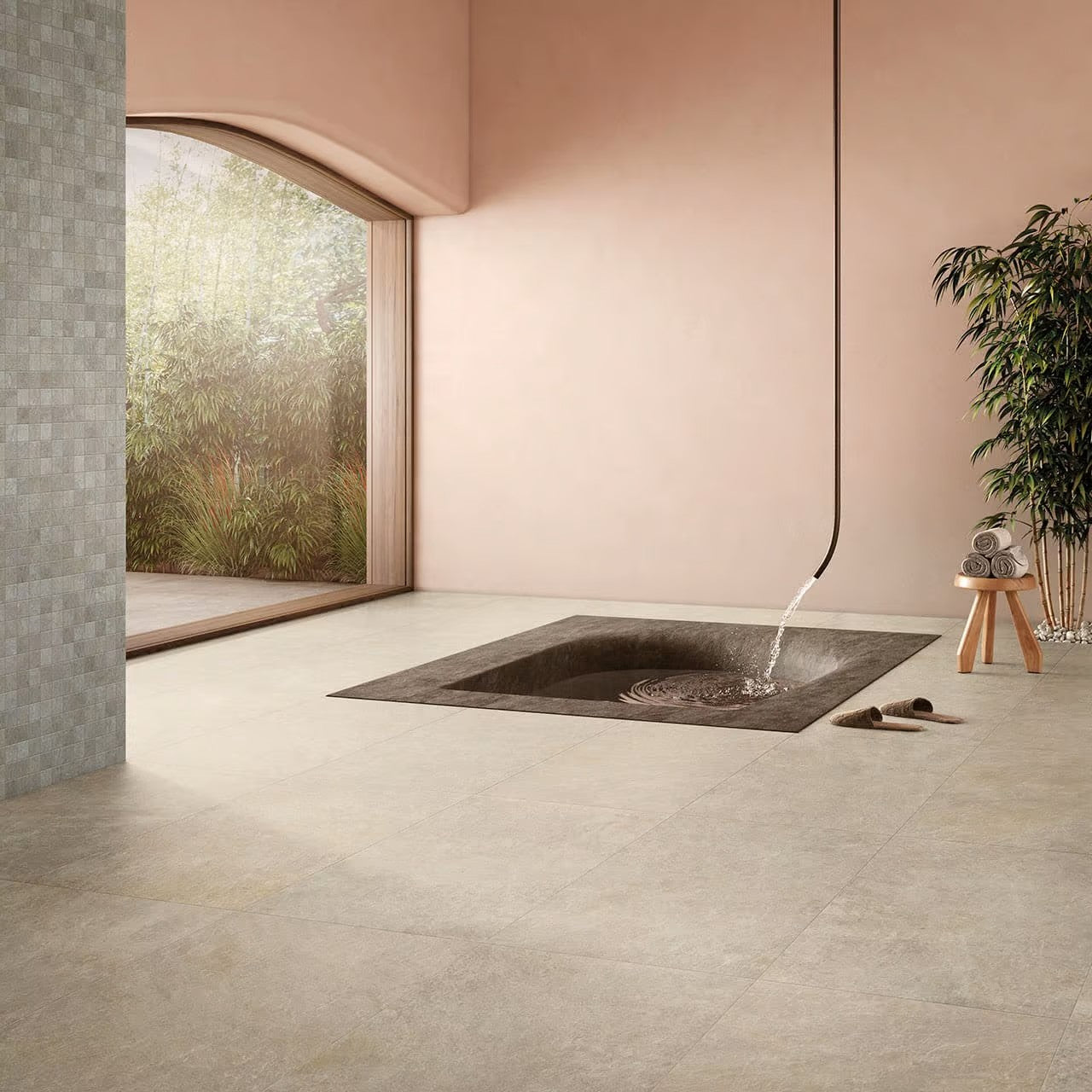 Absolute Clay 600x600mm stone-effect beige floor tiles installed in a minimalist spa room featuring a sunken bath, bamboo plants, and an arched window.