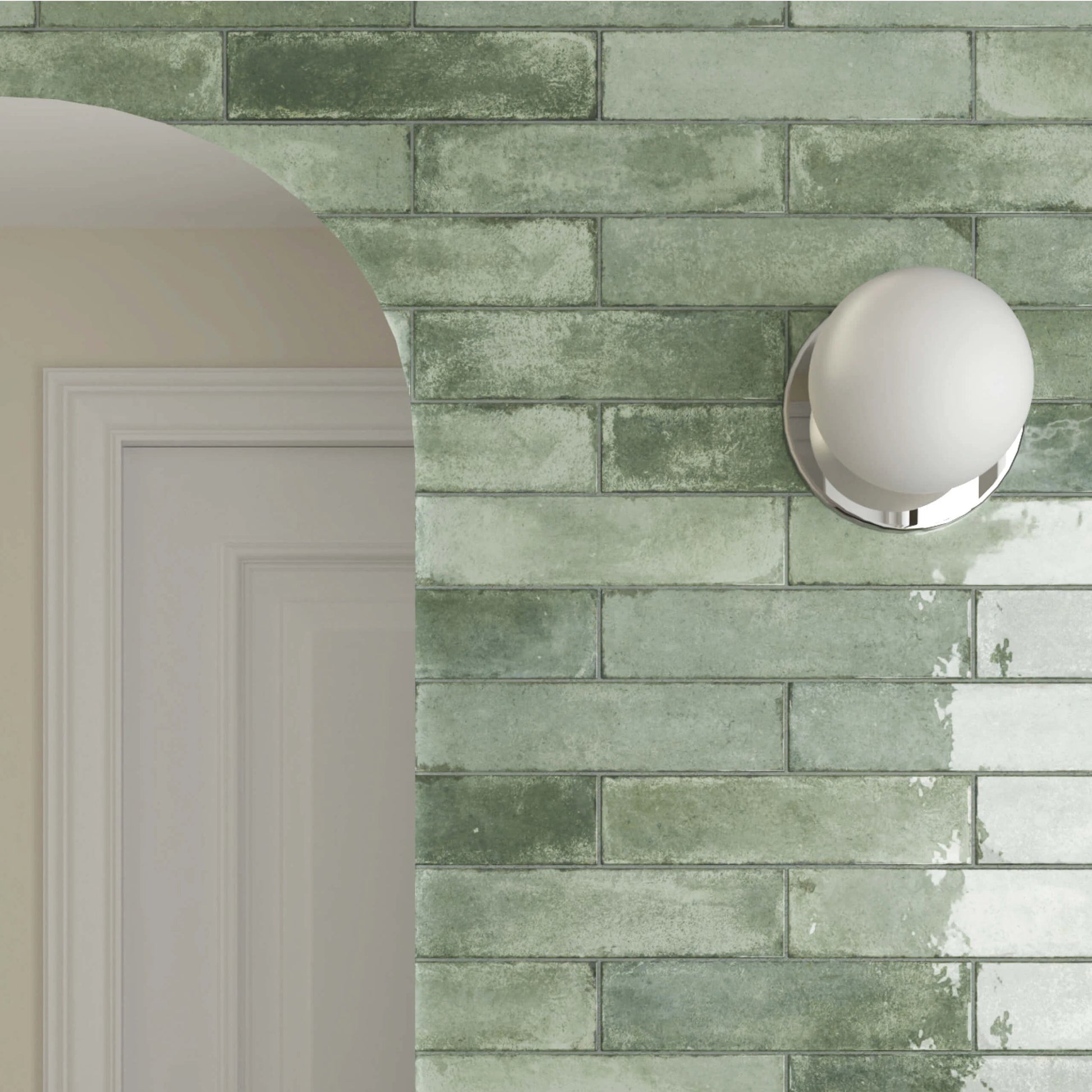 Acquarello Sage Glossy 60x246mm wall tiles in a muted green brick pattern with a chrome globe sconce light and white arched doorway.