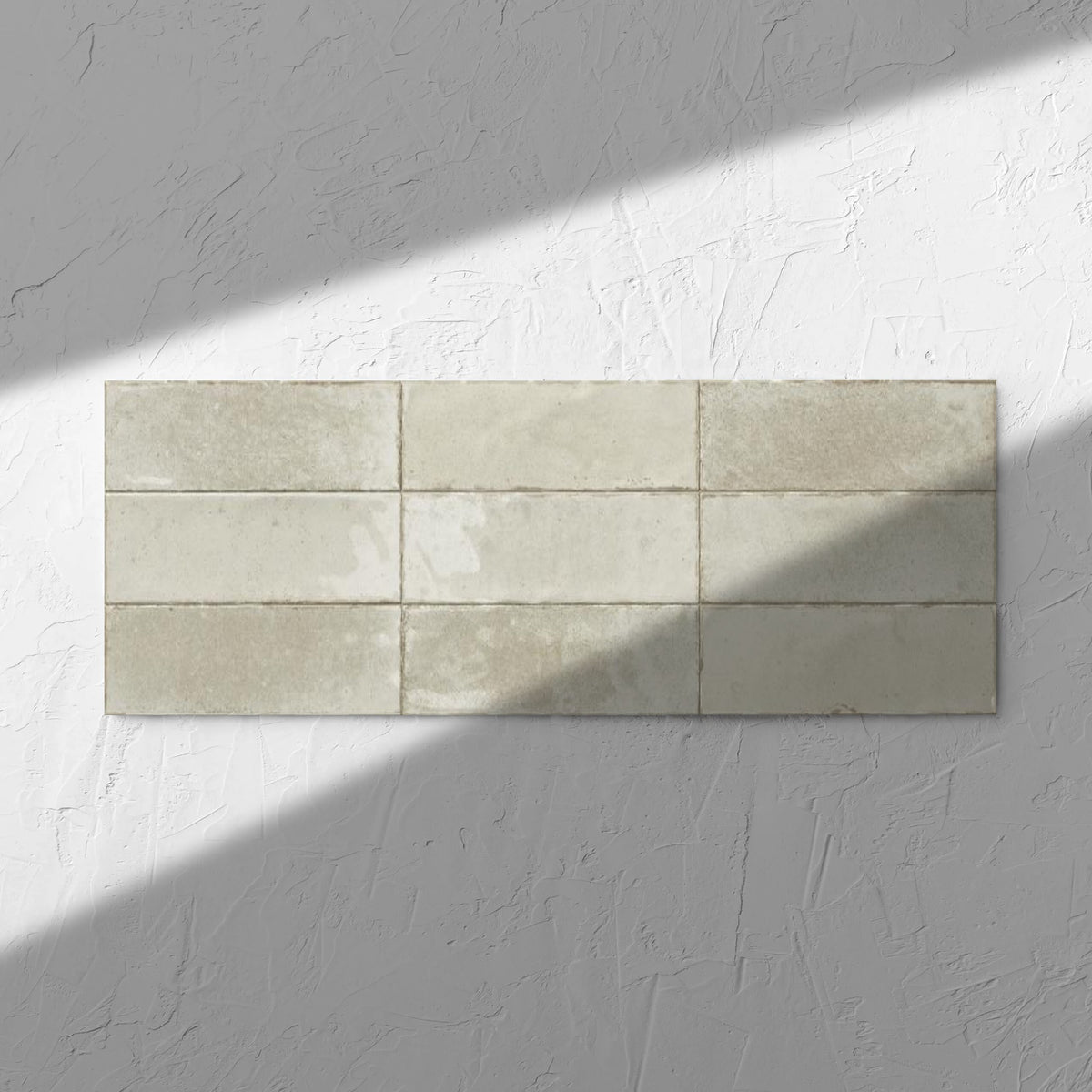 Agadir Ivory 70x280mm tile in soft natural window light, showing the ivory ultra-gloss surface