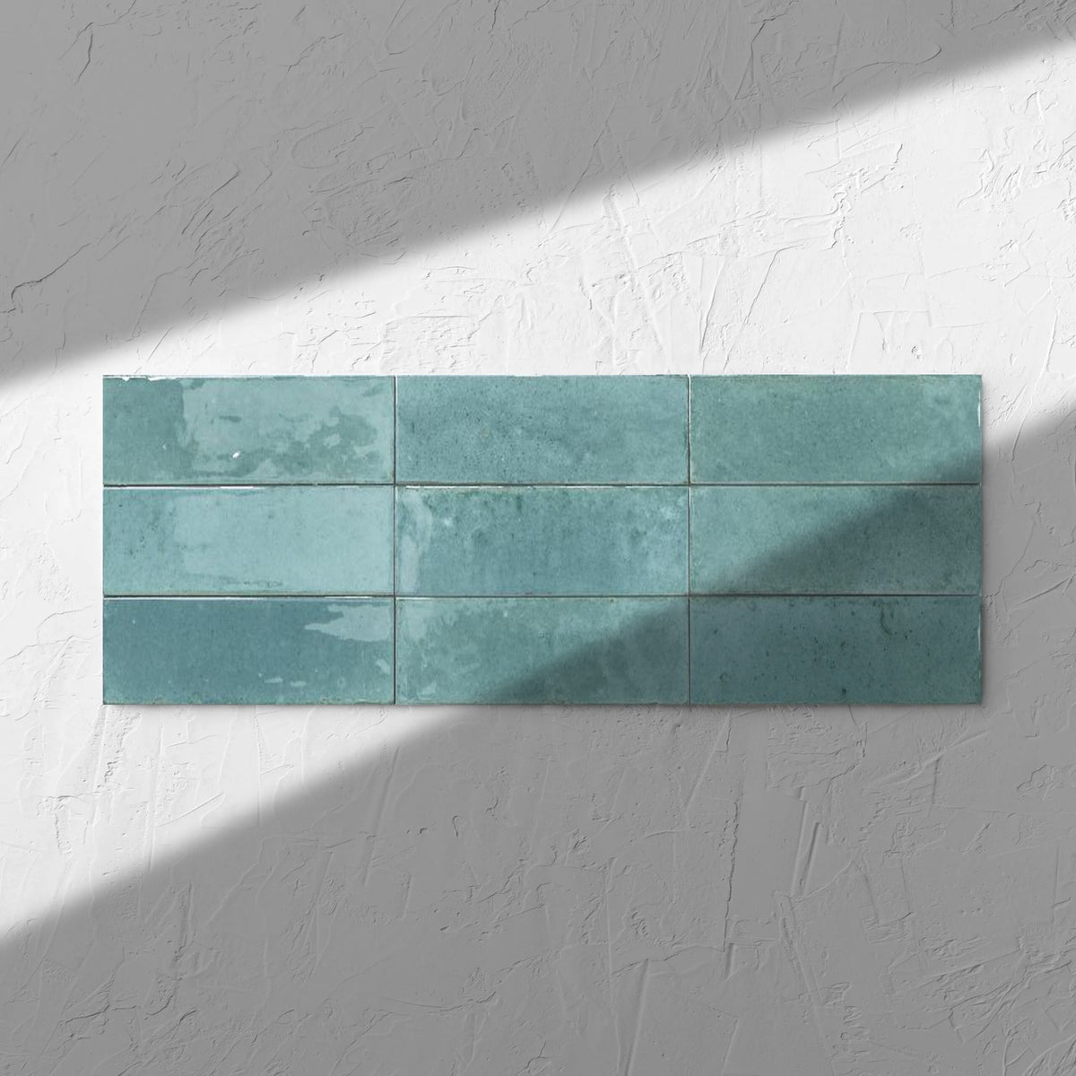 Agadir Turquesa 70x280mm tile in soft natural window light, showing the turquoise ultra-gloss surface