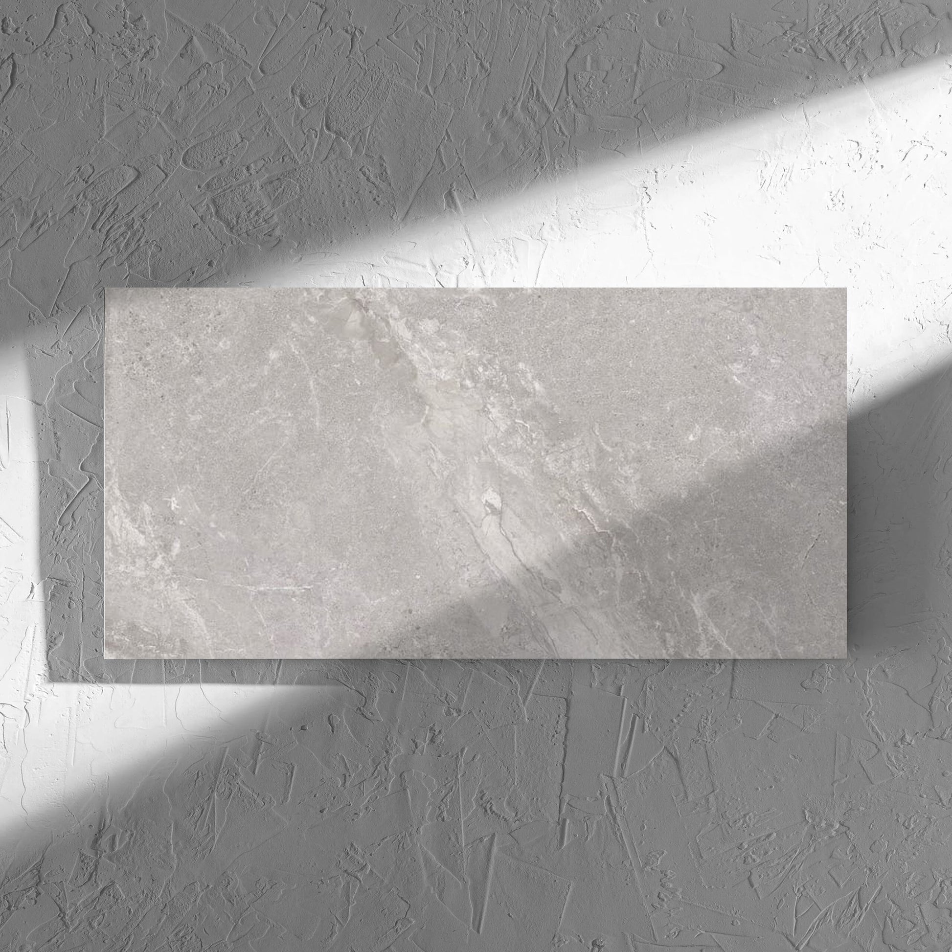 Alpen Stone Grey 300x600mm tile in soft natural window light, showing the tile surface