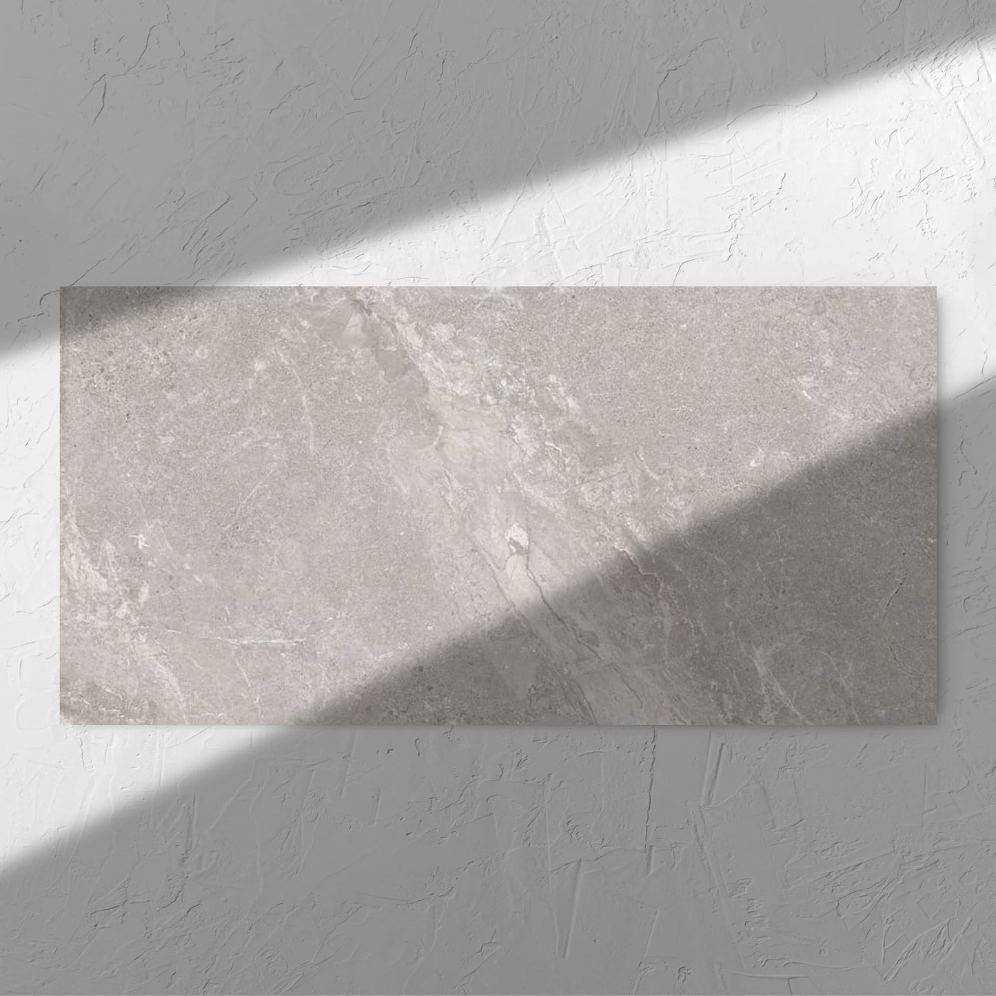 Alpen Stone Grey 600x1200mm tile in soft natural window light, showing the tile surface