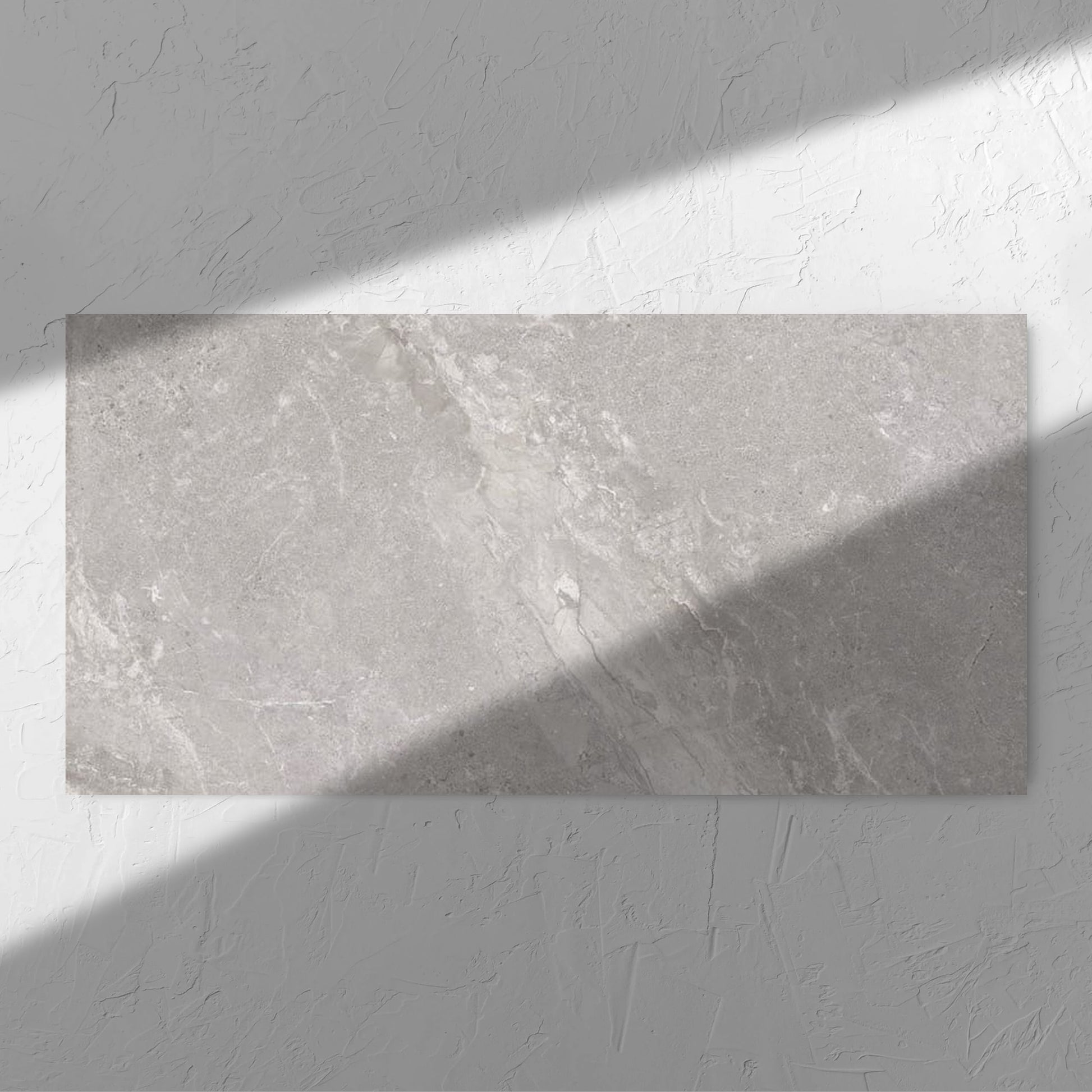 Alpen Stone Grey 600x1200mm tile in soft natural window light, showing the tile surface