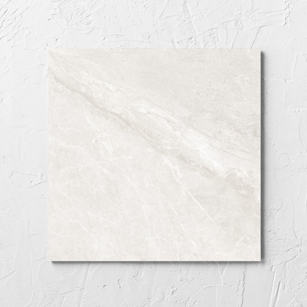 Alpen Stone White 300x300mm tile laid flat on a white rendered wall, showing the white surface