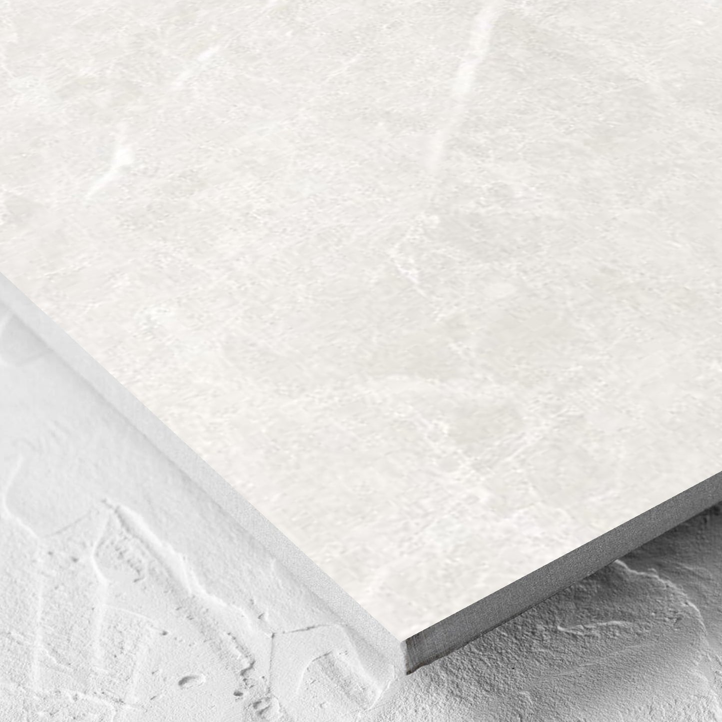 Corner close-up of the Alpen Stone White 600x600mm tile showing the tile surface and the edge profile