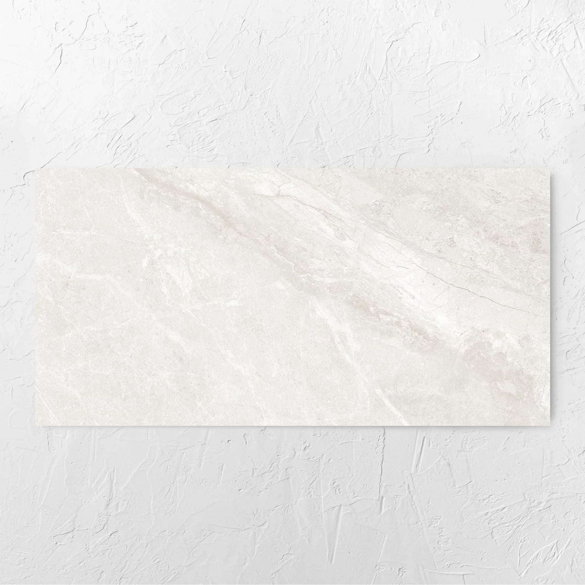 Alpen Stone White Lappato 600x1200mm tile laid flat on a white rendered wall, showing the white surface