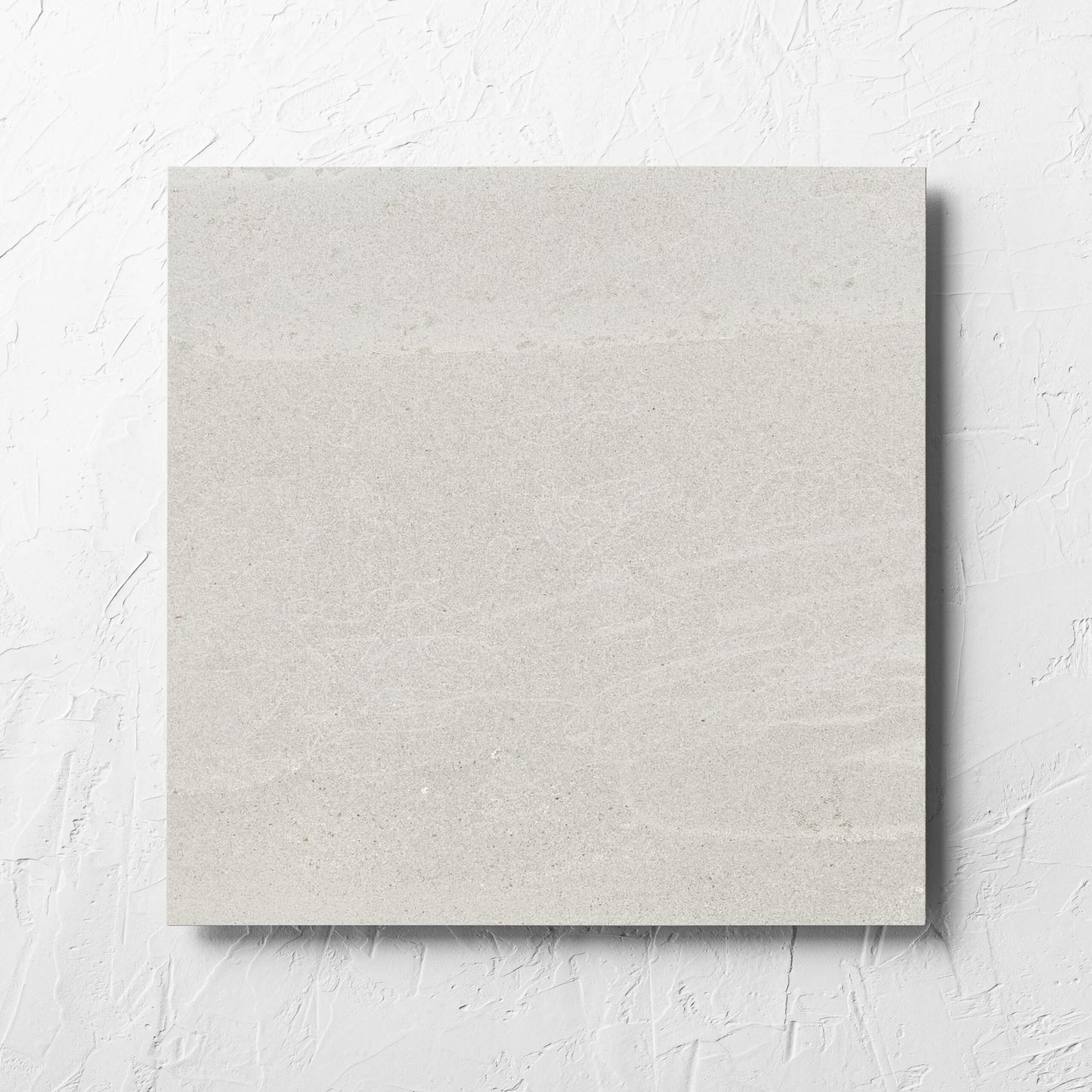 Alps Light Grey Matt 450x450mm tile laid flat on a white rendered wall, showing the tile surface