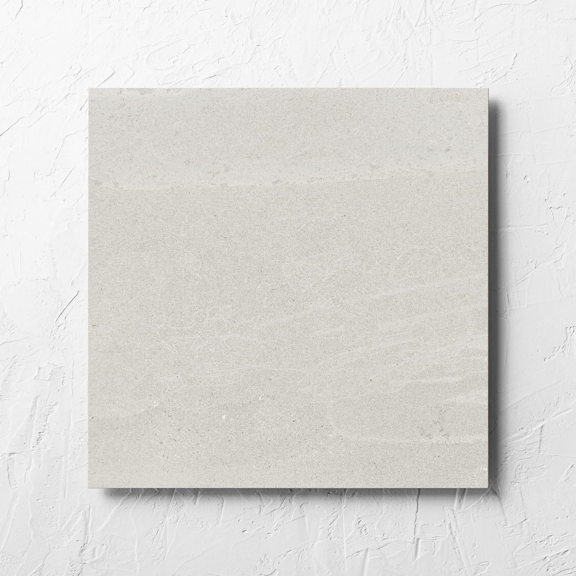 Alps Light Grey Matt 450x450mm tile laid flat on a white rendered wall, showing the tile surface