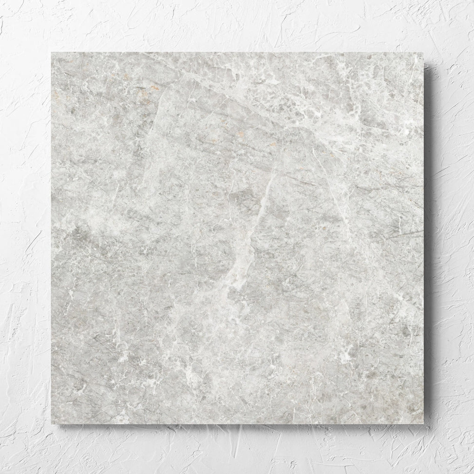 Antalya Beige Matt 600x600mm tile laid flat on a white rendered wall, showing the matt surface