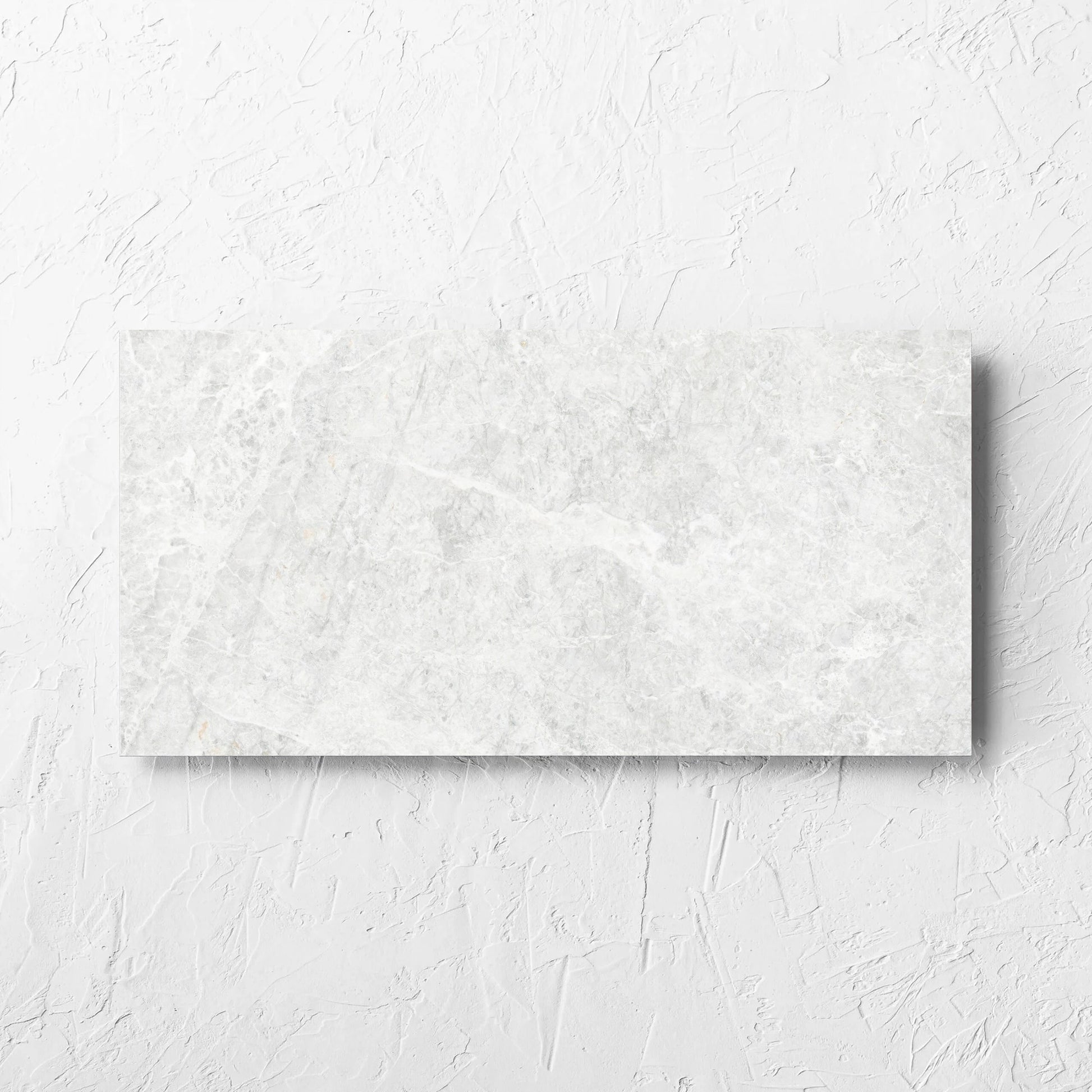 Antalya Bianco Matt 300x600mm tile laid flat on a white rendered wall, showing the matt surface