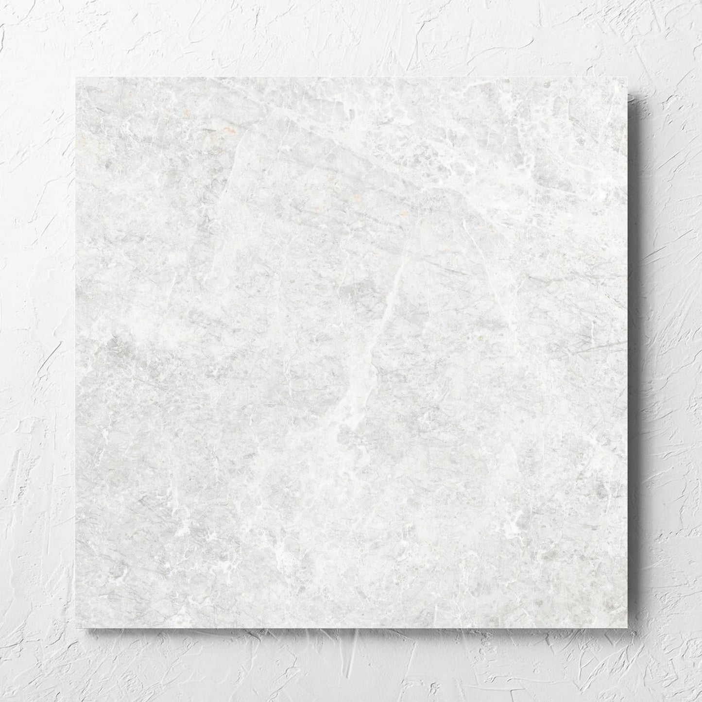 Antalya Bianco Matt 600x600mm tile laid flat on a white rendered wall, showing the matt surface