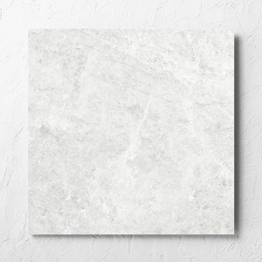 Antalya Bianco Matt 600x600mm tile laid flat on a white rendered wall, showing the matt surface