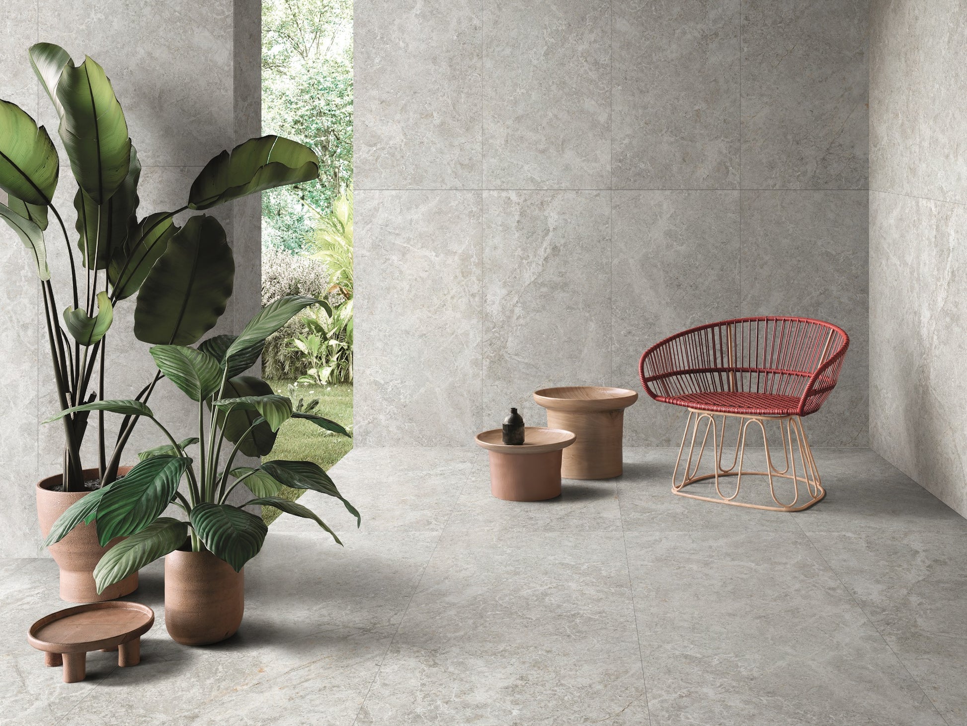 Antalya Silver Matt 300x600mm tiles covering the floor and walls of a contemporary lounge styled with tropical potted plants and a red rattan chair.